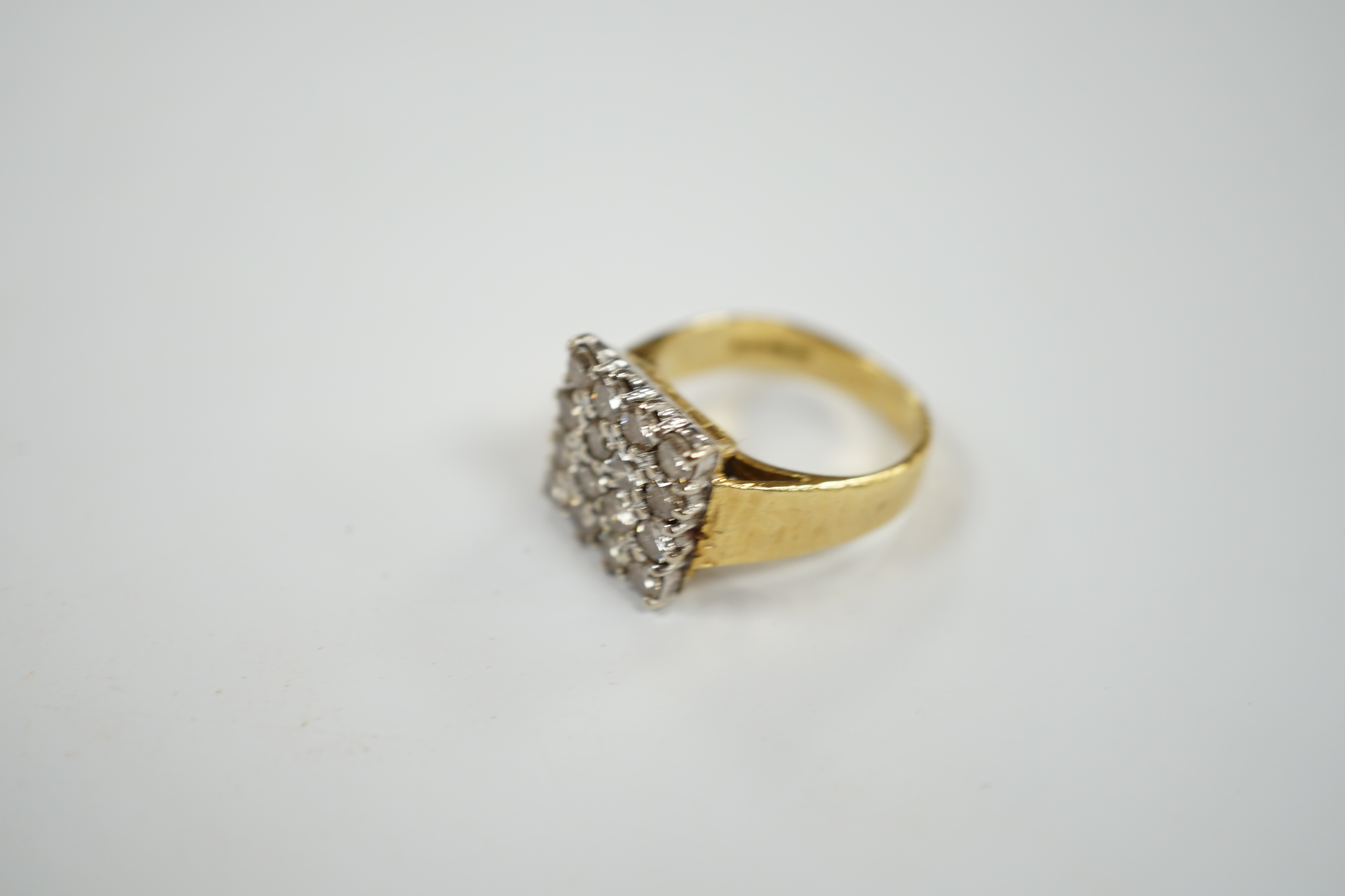 A modern textured 18ct gold and diamond cluster set tablet ring, size K/L, gross weight 6.8 grams.